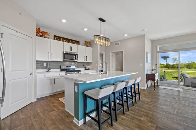 a large kitchen with lots of counter space and stainless steel appliances