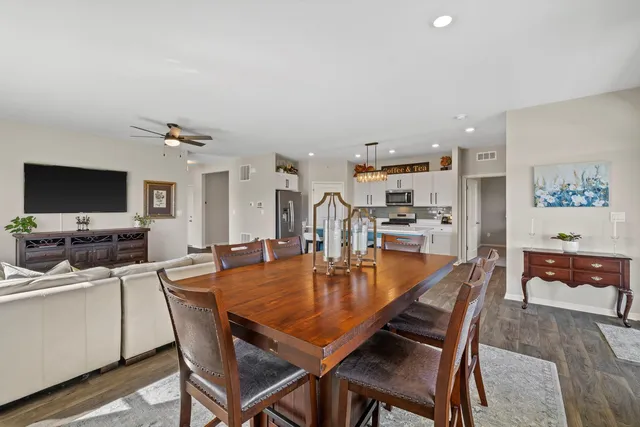 a dining room with furniture and wooden floor