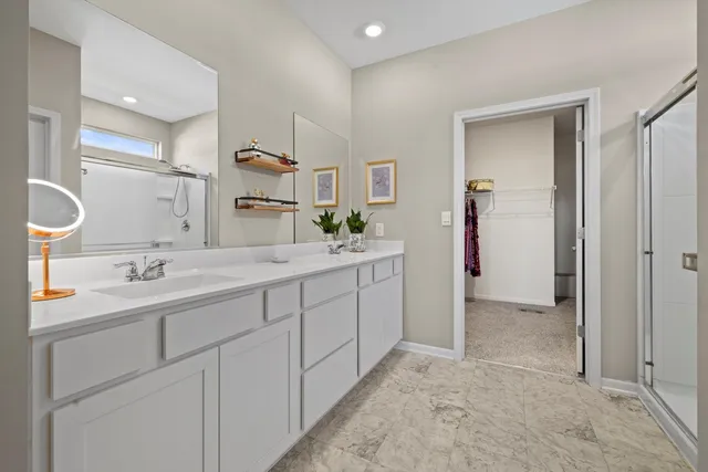 a spacious bathroom with a double vanity sink and a mirror