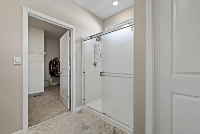 a view of walk in closet with clothes and shoes