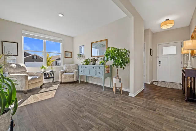a living room with furniture and a potted plant