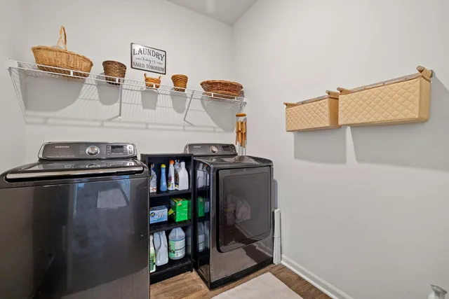 a view of a hallway with wooden floor and a closet