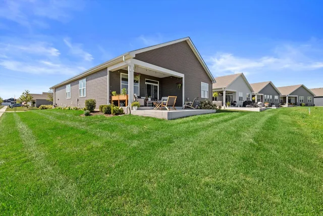 a front view of house with yard and green space