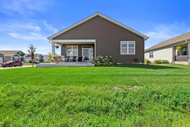 a view of a patio with swimming pool and furniture