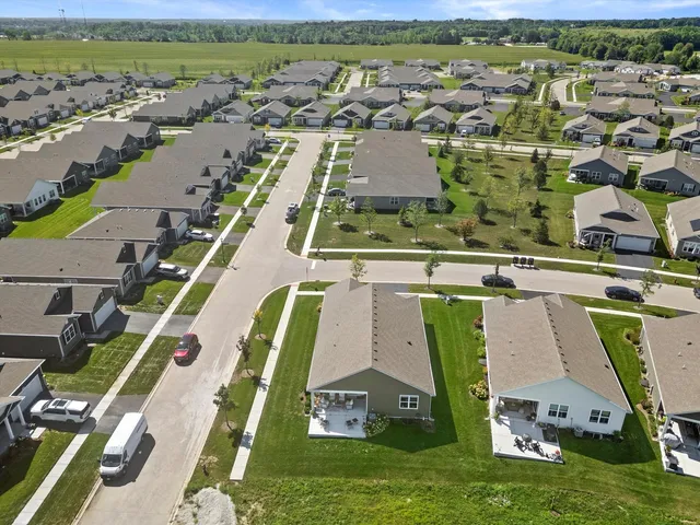 an aerial view of a house with a garden and lake view