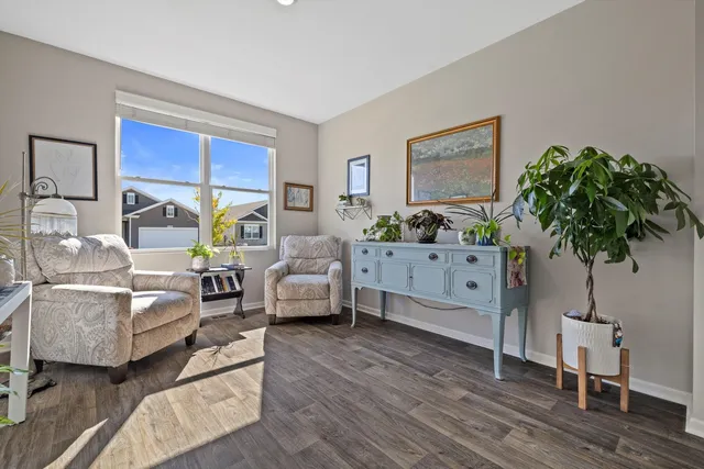 a living room with furniture and a potted plant