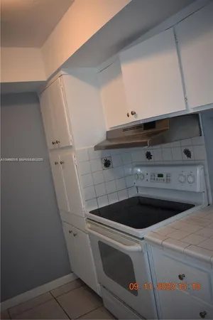a stove top oven sitting inside of a kitchen