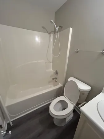 a bathroom with a toilet a sink and bathtub