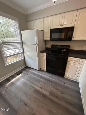 a view of kitchen with a microwave and wooden floor