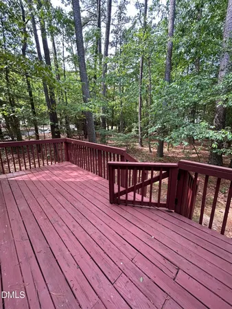 a balcony with wooden floor and outdoor space