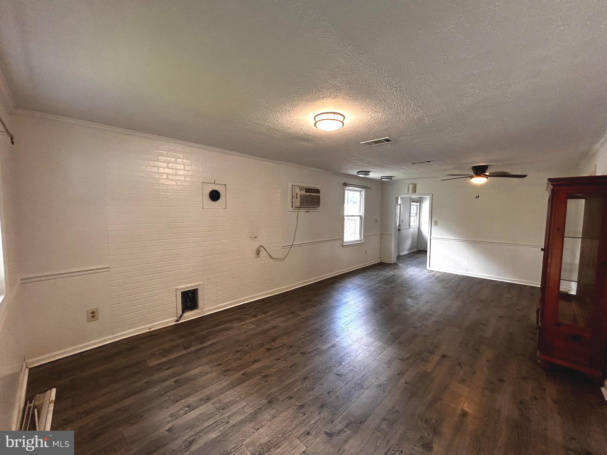 703 White Oak Road White Post, VA 22663 - Photo 6 of 23 an empty room with wooden floor and windows