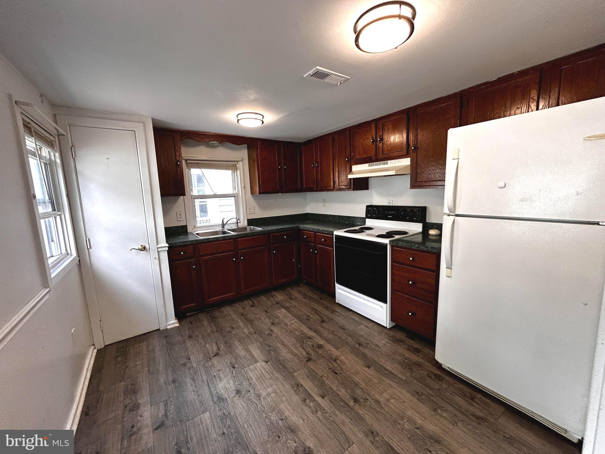 703 White Oak Road White Post, VA 22663 - Photo 7 of 23 a kitchen with stainless steel appliances granite countertop a refrigerator a sink a stove with wooden floors and cabinets