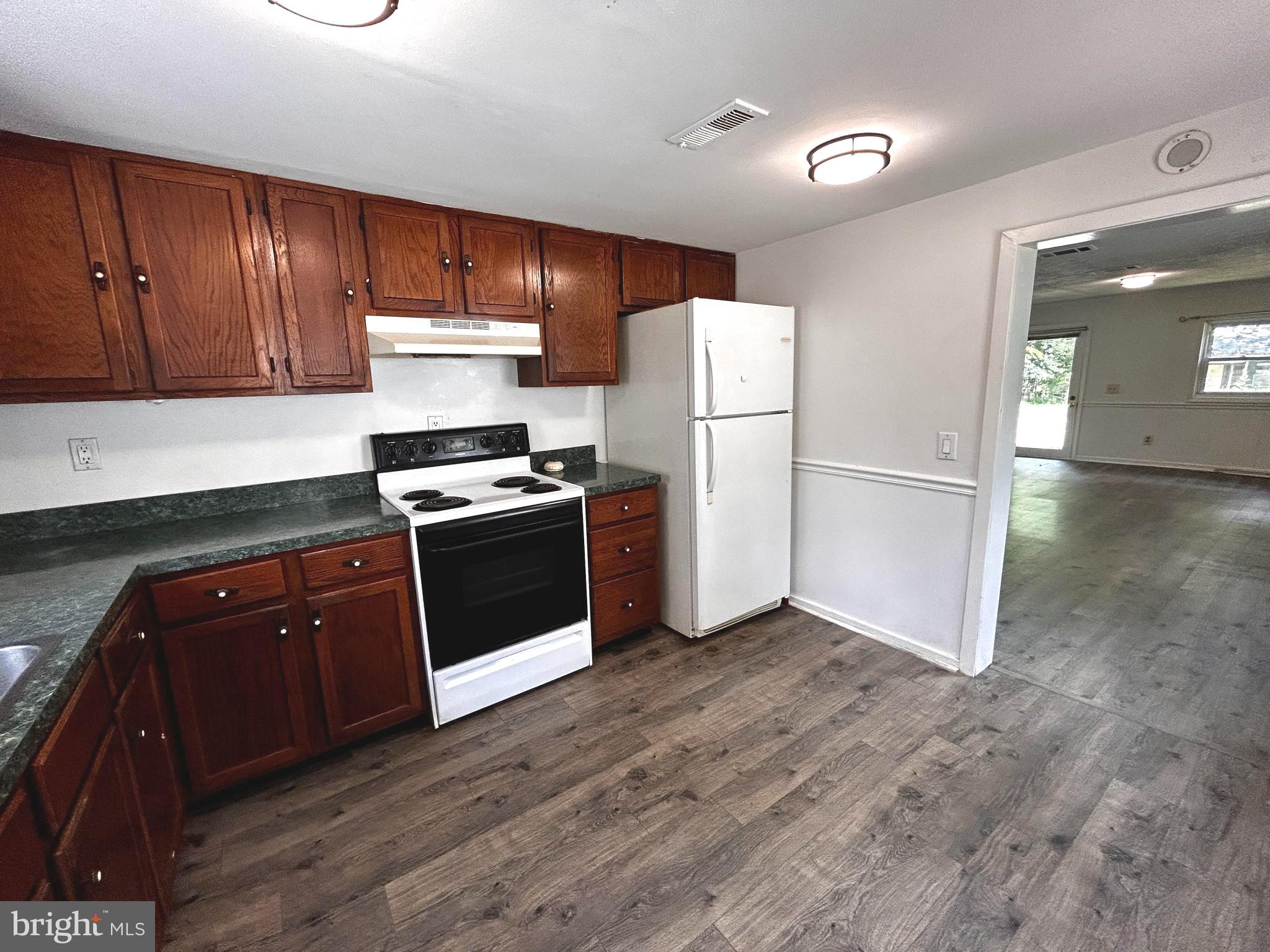 703 White Oak Road White Post, VA 22663 - Photo 8 of 23 a kitchen with a refrigerator sink and cabinets
