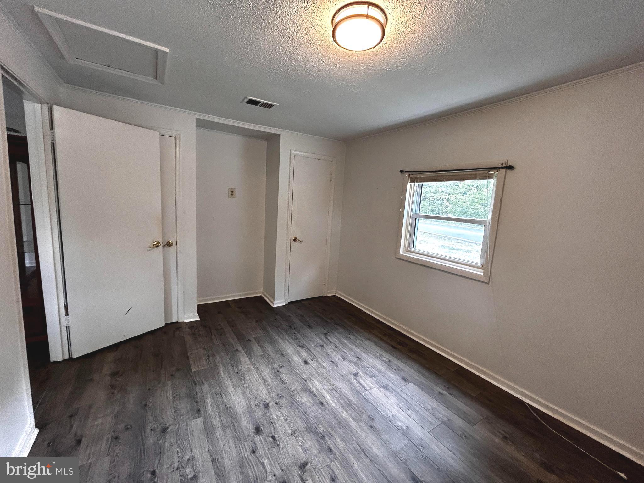 703 White Oak Road White Post, VA 22663 - Photo 9 of 23 an empty room with wooden floor and windows
