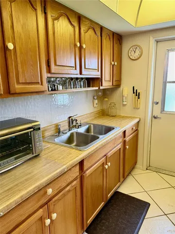 a kitchen with stainless steel appliances granite countertop a sink a stove and cabinets