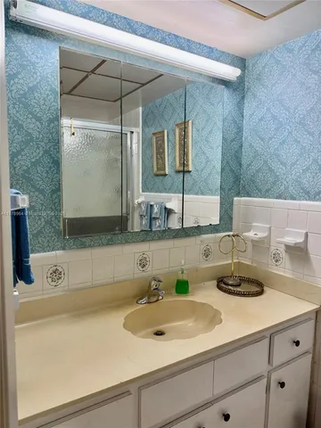 a bathroom with a sink and a mirror