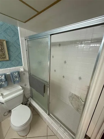 a bathroom with a toilet and a shower