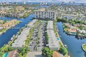an aerial view of lake and residential houses with outdoor space