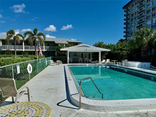 a view of a house with a backyard porch and sitting area