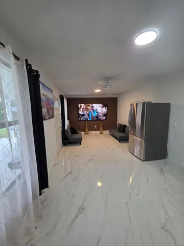 a view of a livingroom with furniture and staircase