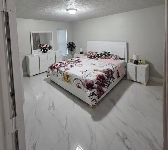 a bed sitting in a bedroom next to a window