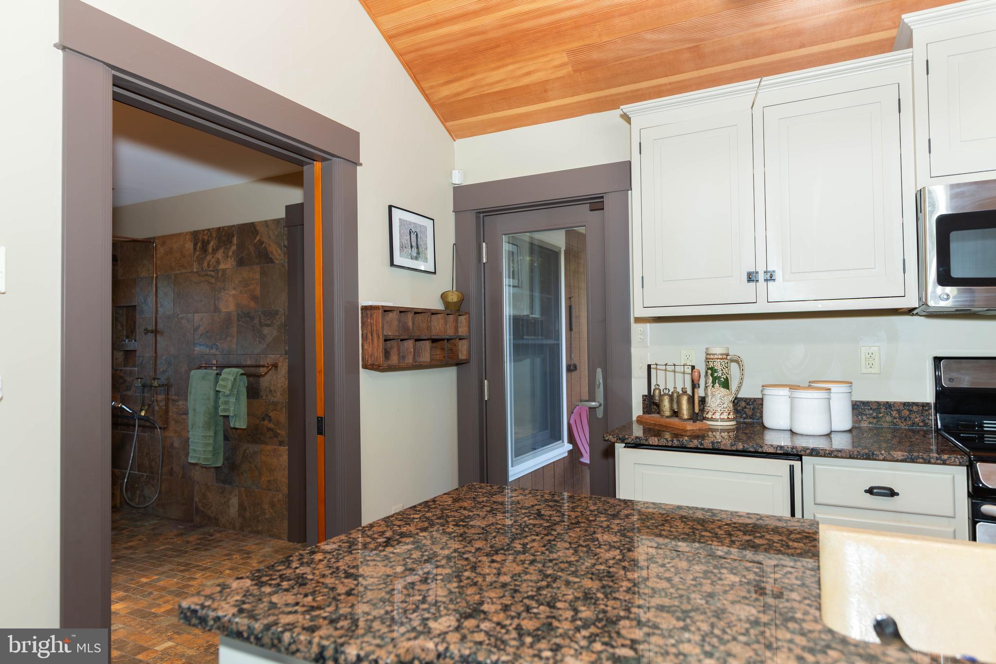 1312 John Rissler Road Charles Town, WV 25414 - Photo 14 of 24 a kitchen with stainless steel appliances kitchen island granite countertop a refrigerator and cabinets