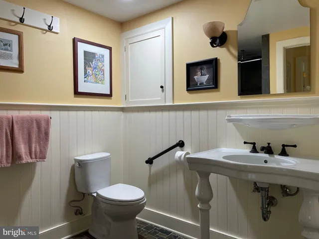 a bathroom with a toilet sink and mirror