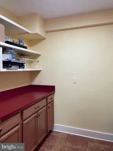 a kitchen with a refrigerator and cabinets