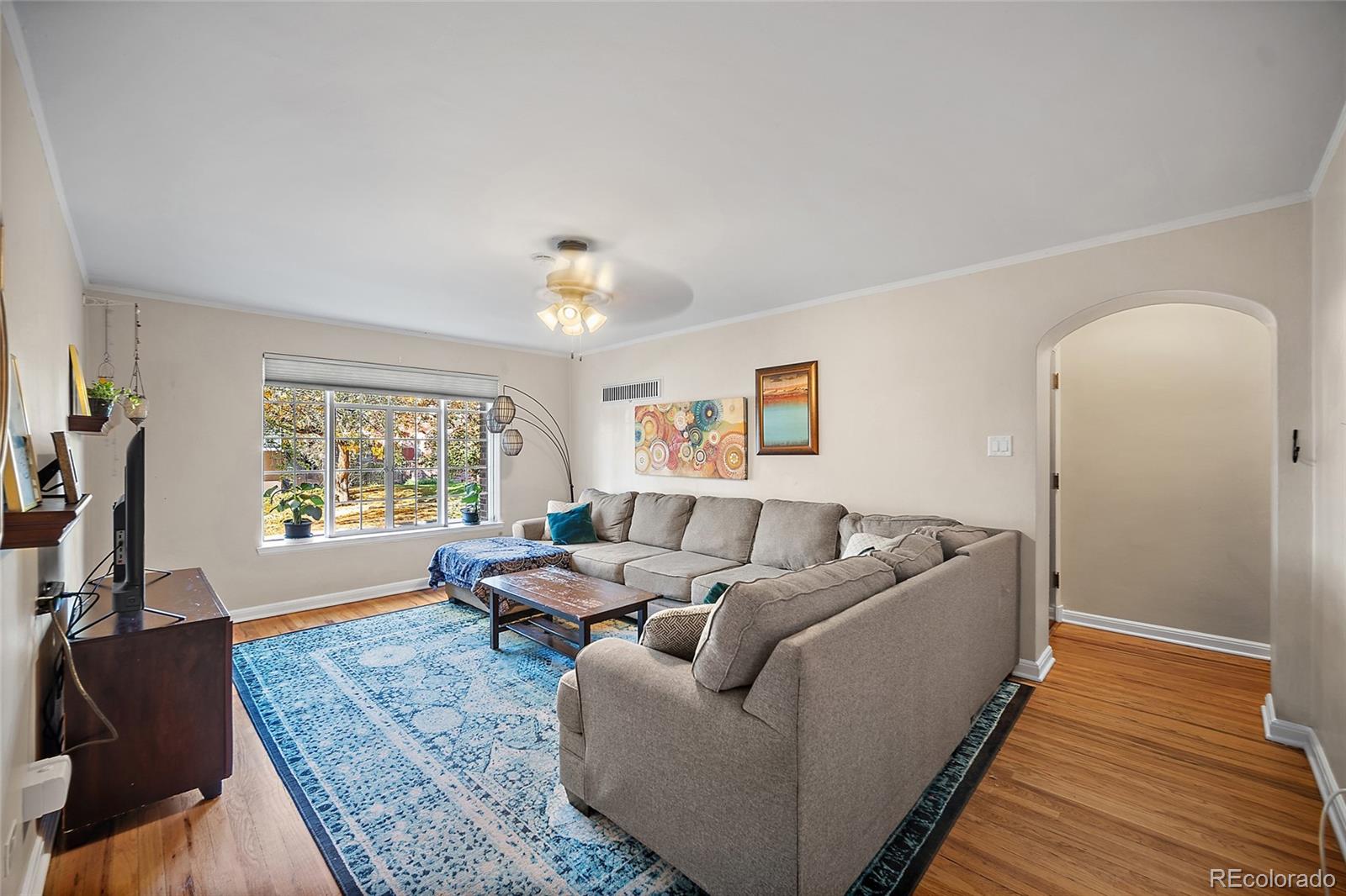 1410 Vine Street, Unit 2 Denver, CO 80206 - Photo 7 of 24 a living room with furniture and a flat screen tv