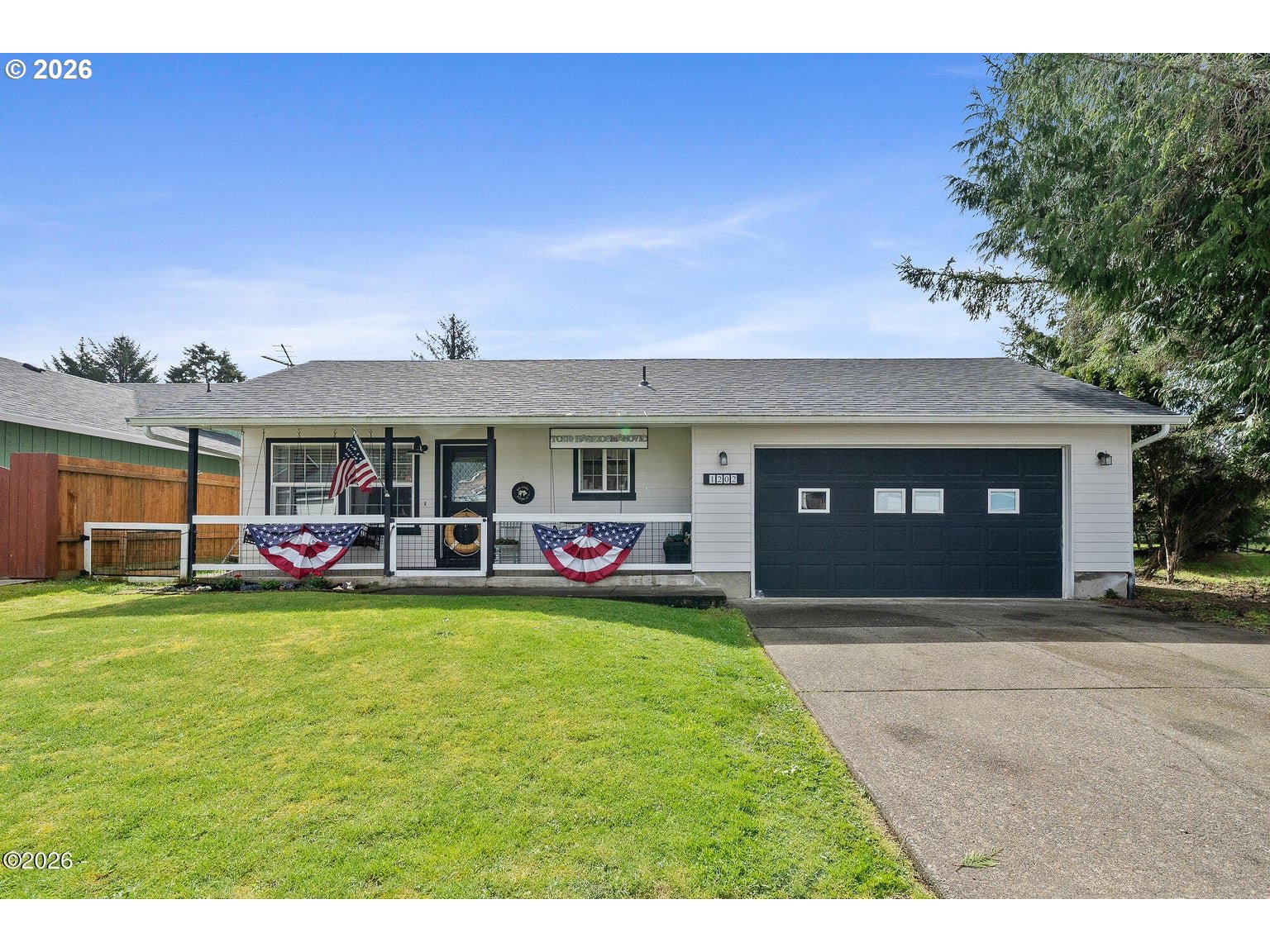 1202 North First Avenue Rockaway Beach, OR 97136 - Photo 2 of 28 a view of a house with a yard and sitting area