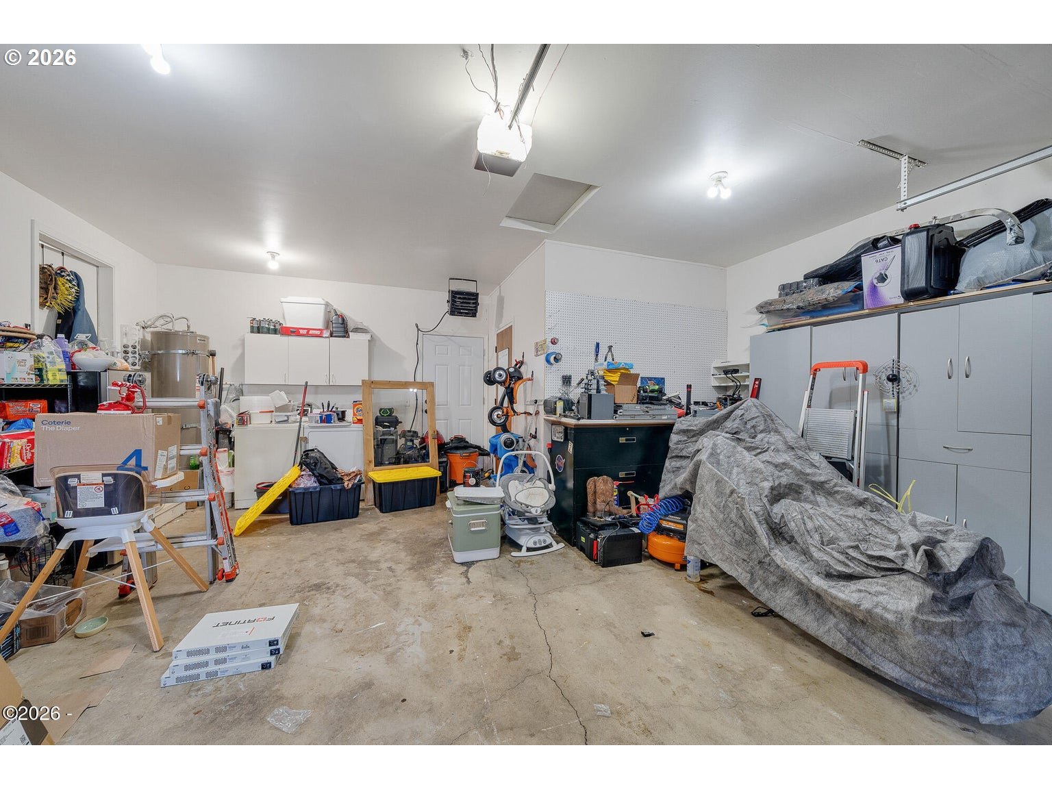 1202 North First Avenue Rockaway Beach, OR 97136 - Photo 24 of 28 a storage room with lots of clutter and cars