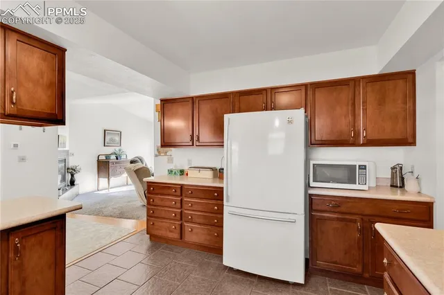 a white refrigerator freezer sitting in a kitchen