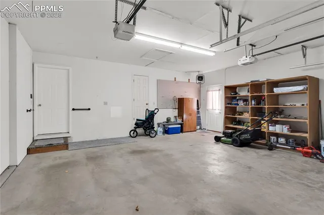 a view of a garage with furniture and a ceiling fan