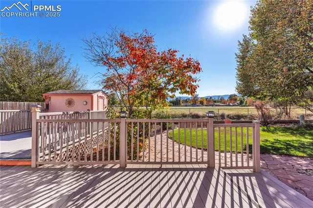 a view of a roof deck with wooden floor and fence