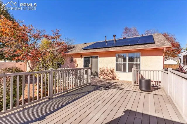 a view of a house with wooden deck
