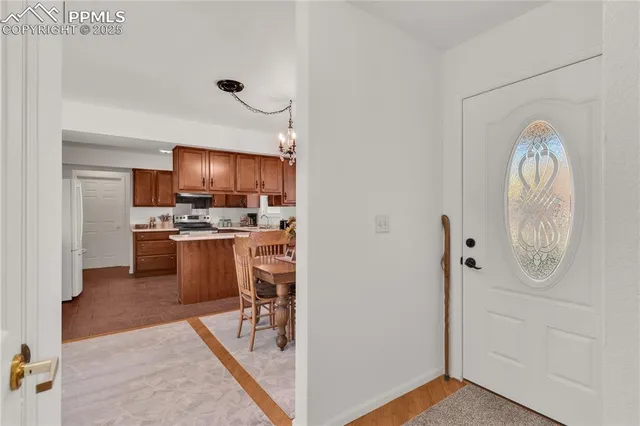 a kitchen with stainless steel appliances granite countertop a refrigerator stove and a sink