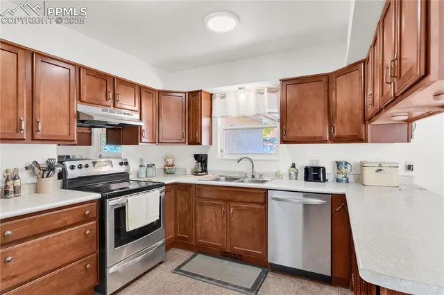 a kitchen with a sink a stove and cabinets