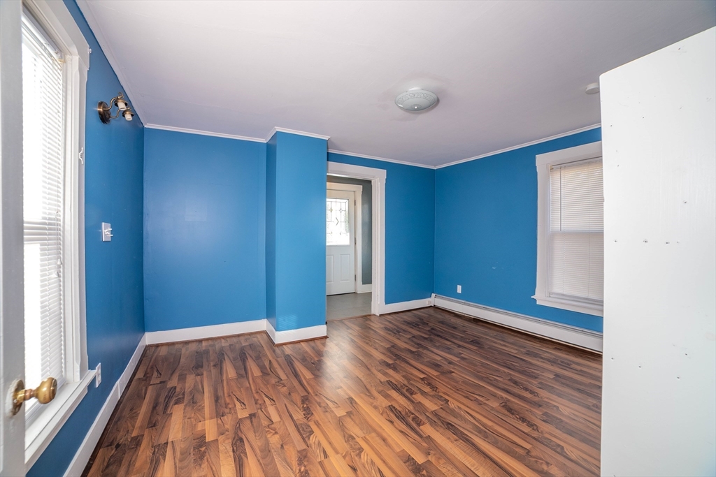 145 Center Road Dudley, MA 01571 - Photo 12 of 32 a view of an empty room with wooden floor and a window