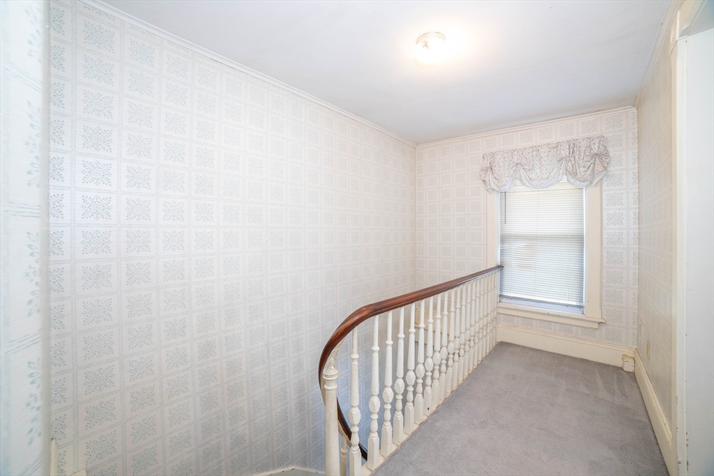 145 Center Road Dudley, MA 01571 - Photo 14 of 32 a view of a hallway with a white walls