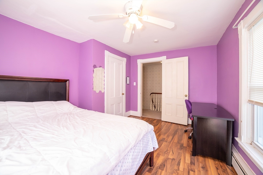 145 Center Road Dudley, MA 01571 - Photo 19 of 32 a bedroom with a bed and a chandelier