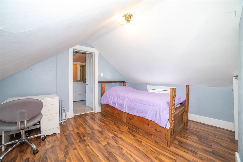 145 Center Road Dudley, MA 01571 - Photo 22 of 32 a bedroom with a bed and a chair