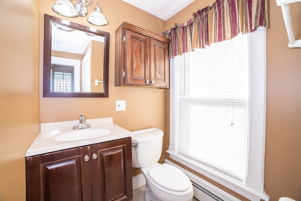 145 Center Road Dudley, MA 01571 - Photo 23 of 32 a bathroom with a sink a toilet and a mirror