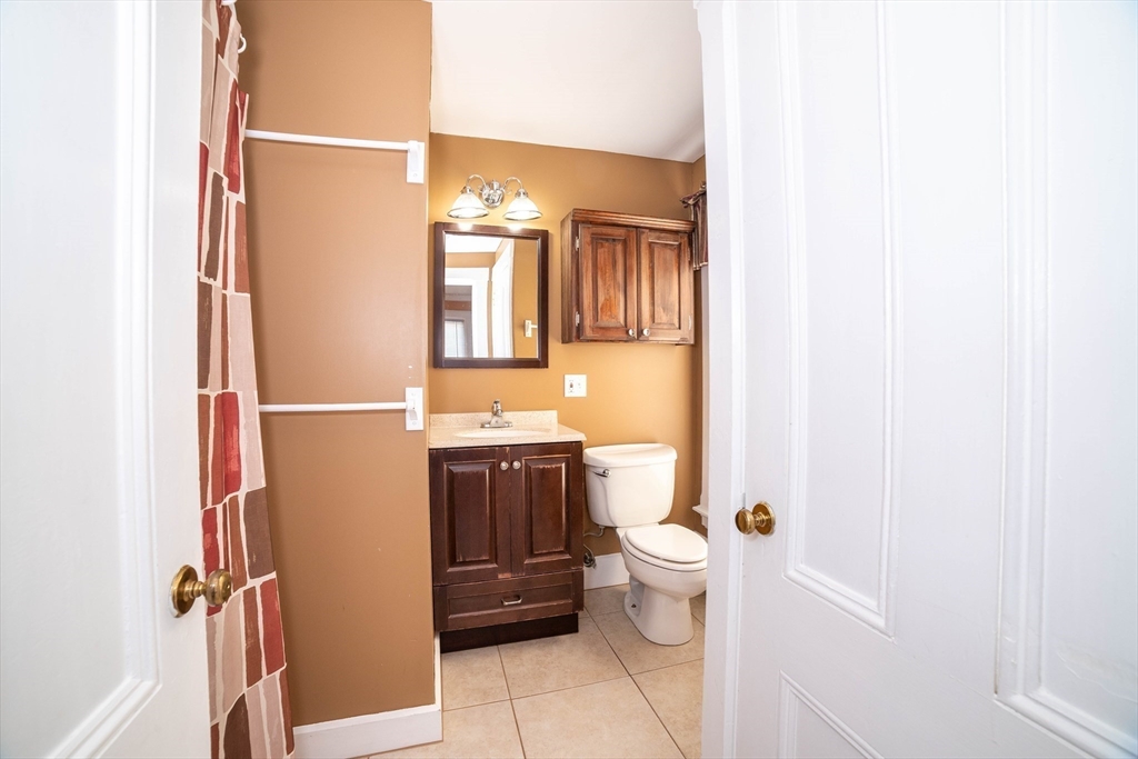 145 Center Road Dudley, MA 01571 - Photo 24 of 32 a bathroom with a granite countertop toilet and a sink