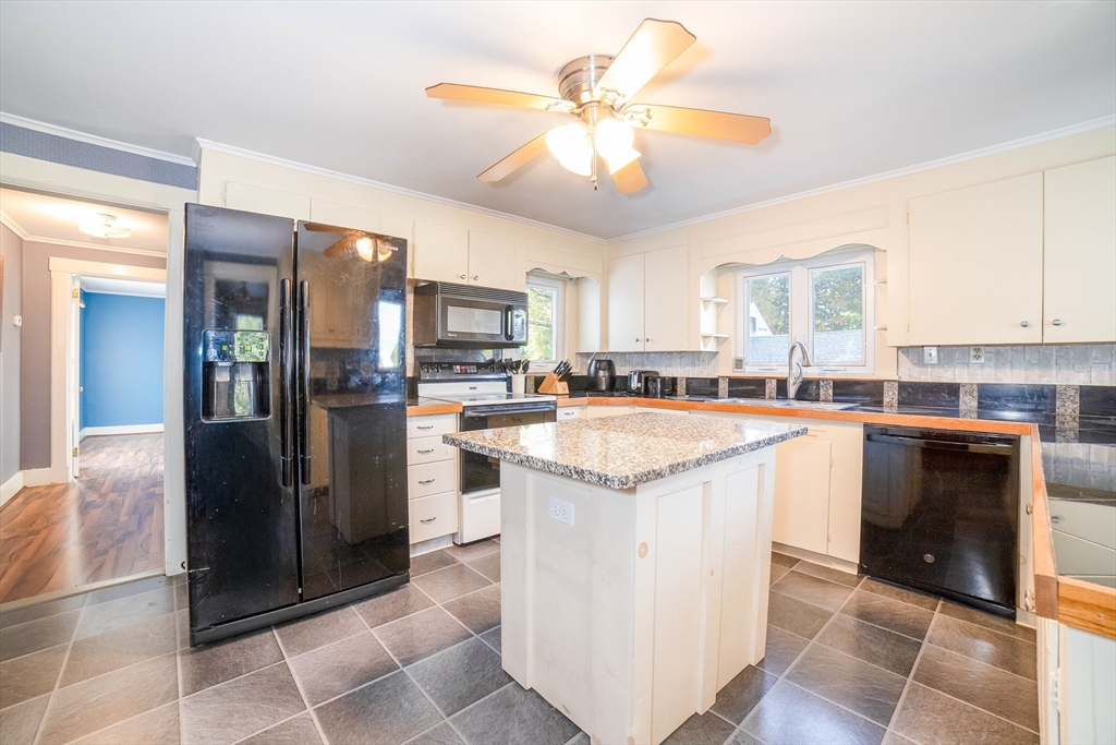 145 Center Road Dudley, MA 01571 - Photo 9 of 32 a kitchen with a stove a refrigerator and a sink