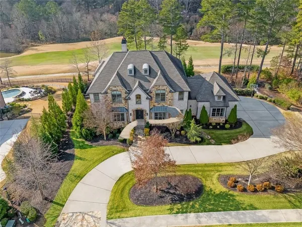 a front view of a house with a garden and yard
