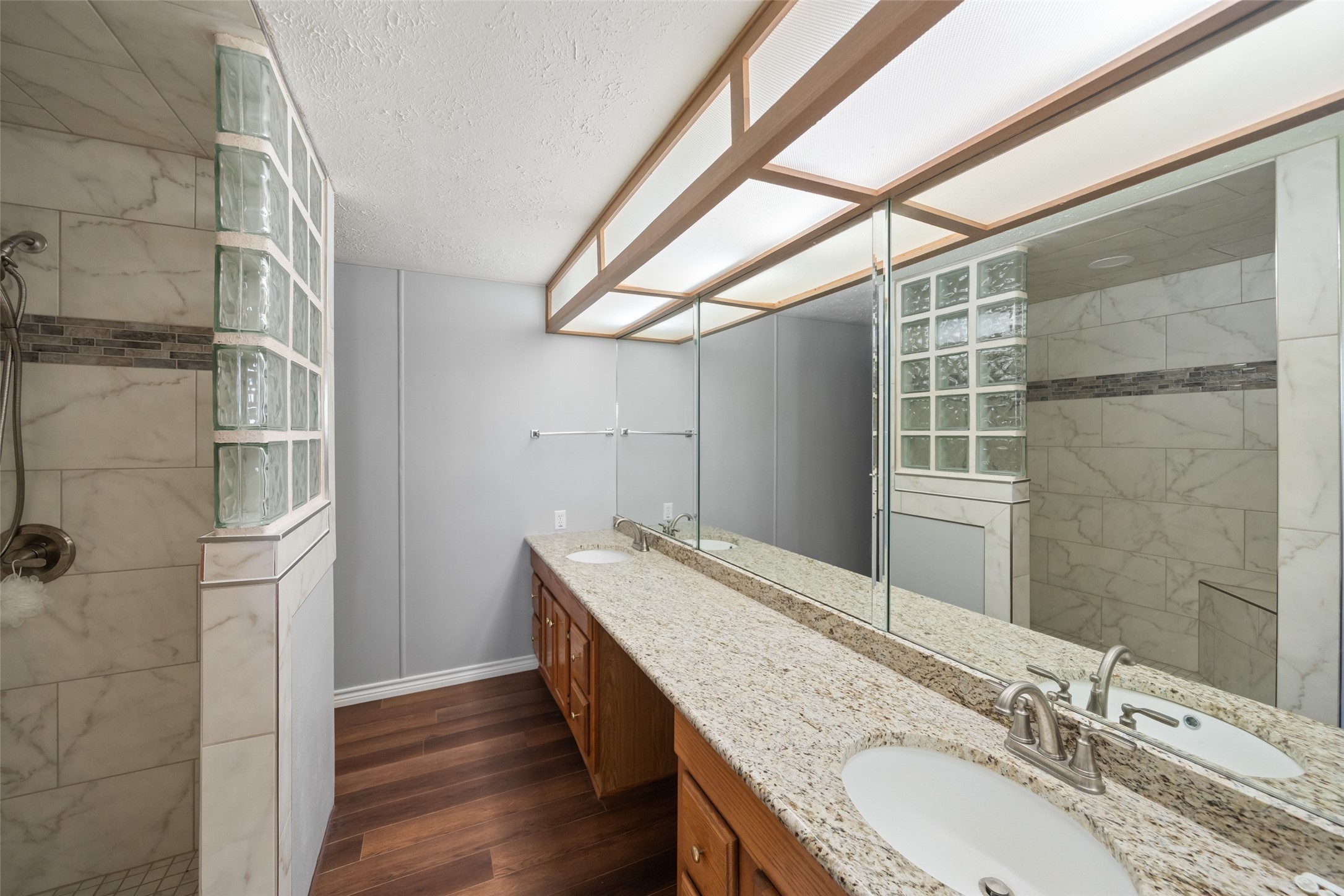 119 Fm 1891 Shiner, TX 77984 - Photo 11 of 40 a bathroom with a granite countertop sink a mirror and shower