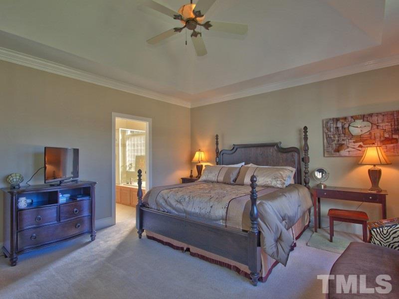 224 Waterville Street Raleigh, NC 27603 - Photo 13 of 25 a bedroom with a bed and a chandelier