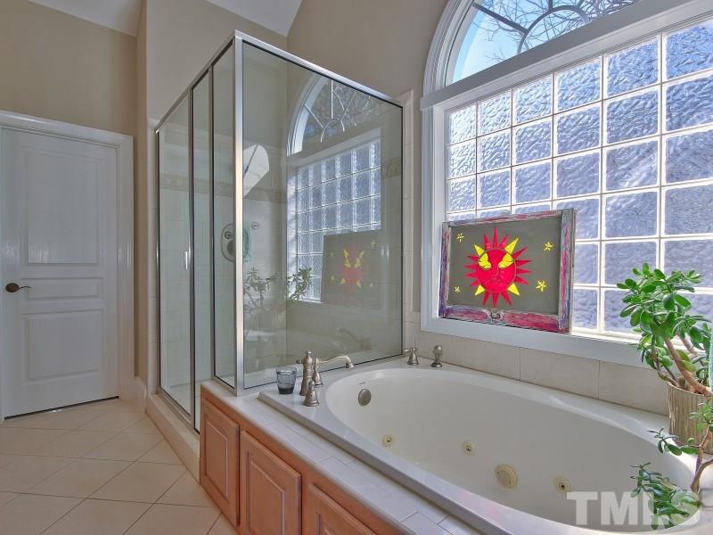 224 Waterville Street Raleigh, NC 27603 - Photo 14 of 25 a bathroom with a bathtub and a shower