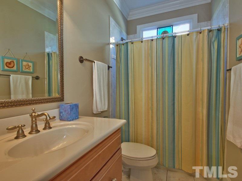 224 Waterville Street Raleigh, NC 27603 - Photo 18 of 25 a bathroom with a sink a toilet and shower