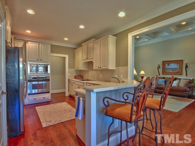 224 Waterville Street Raleigh, NC 27603 - Photo 6 of 25 a kitchen with stainless steel appliances granite countertop a stove a sink and a refrigerator